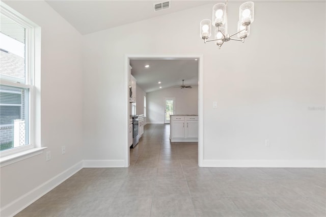 unfurnished dining area with light tile patterned flooring, a chandelier, and vaulted ceiling