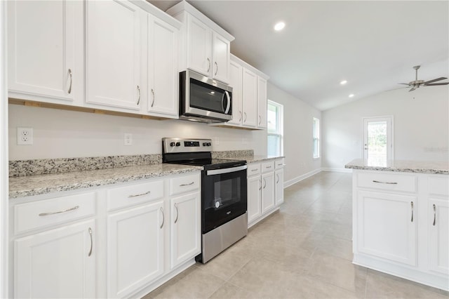 kitchen featuring white cabinetry, light stone counters, vaulted ceiling, ceiling fan, and stainless steel appliances