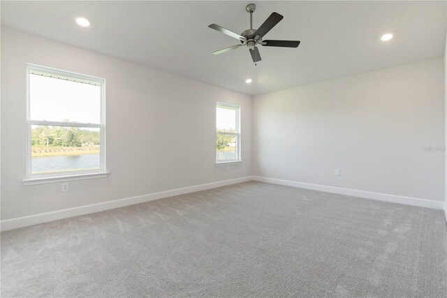 carpeted empty room featuring ceiling fan