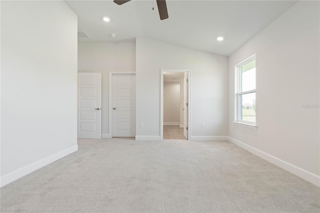 carpeted empty room featuring ceiling fan and lofted ceiling