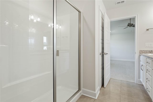 bathroom with vanity, an enclosed shower, and tile patterned floors