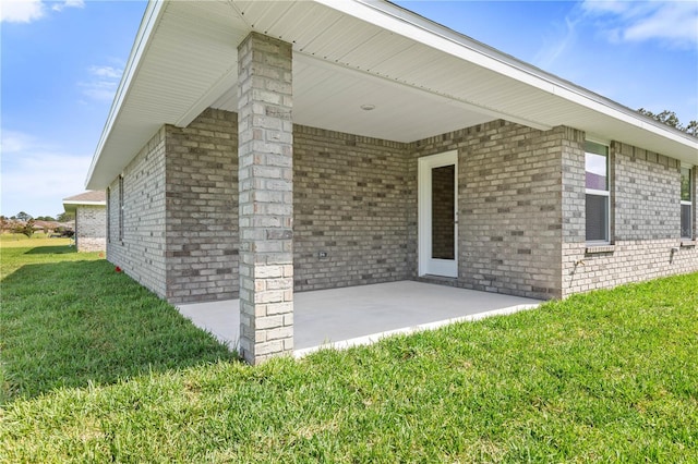 exterior space with a patio area and a lawn