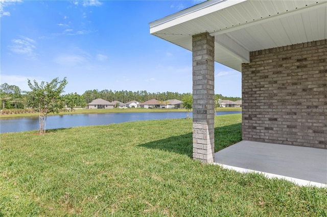 view of yard with a patio area and a water view