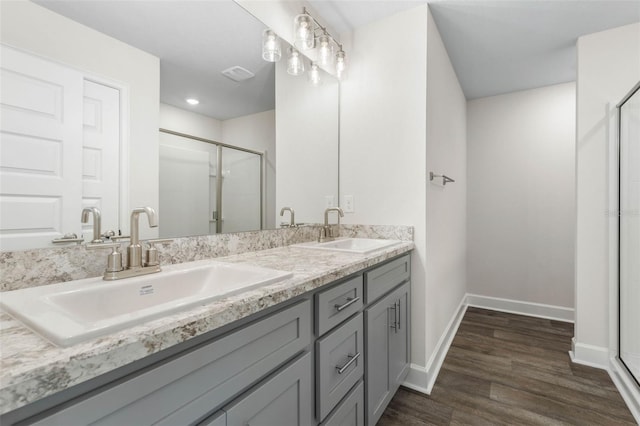 7 Whitcock Ln, Palm Coast, FL 32164 - bathroom featuring a shower stall, double vanity, wood finished floors, baseboards, and recessed lighting