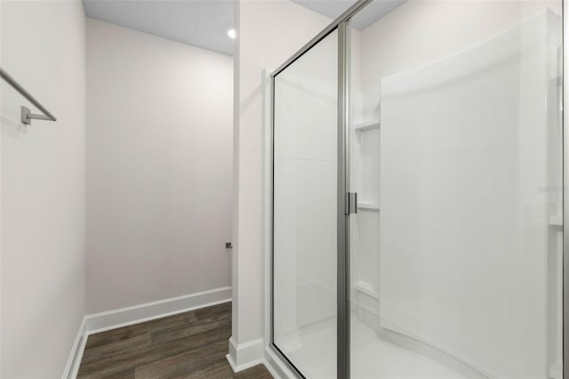 7 Whitcock Ln, Palm Coast, FL 32164 - bathroom featuring a stall shower, wood finished floors, and baseboards