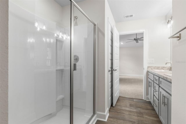 7 Whitcock Ln, Palm Coast, FL 32164 - bathroom featuring vanity, a shower stall, wood finished floors, a ceiling fan, and baseboards