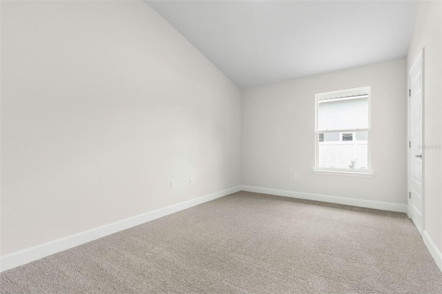 7 Whitcock Ln, Palm Coast, FL 32164 - unfurnished room with carpet floors, baseboards, and lofted ceiling