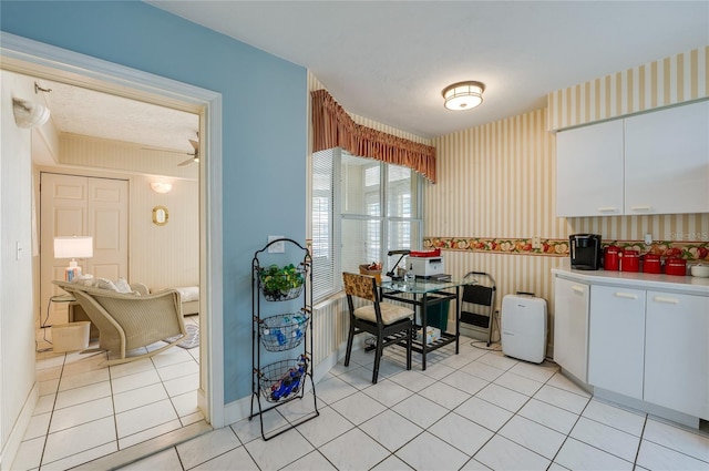 kitchen featuring white cabinetry, ceiling fan, and light tile patterned flooring