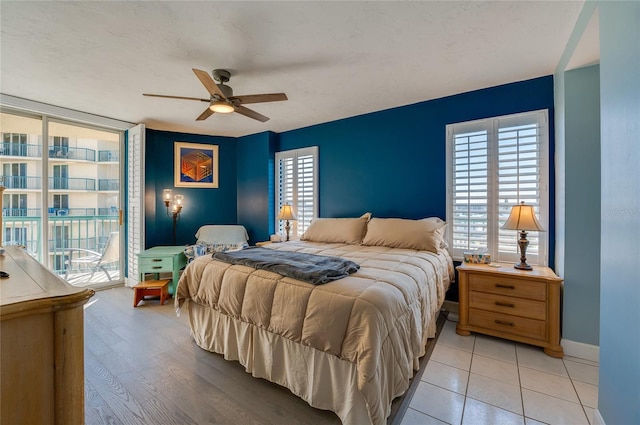 bedroom with access to exterior, ceiling fan, and light hardwood / wood-style flooring