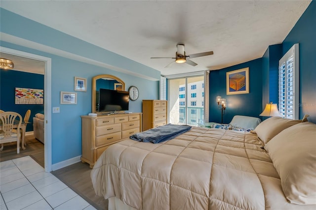 bedroom featuring ceiling fan, floor to ceiling windows, access to exterior, and light hardwood / wood-style floors