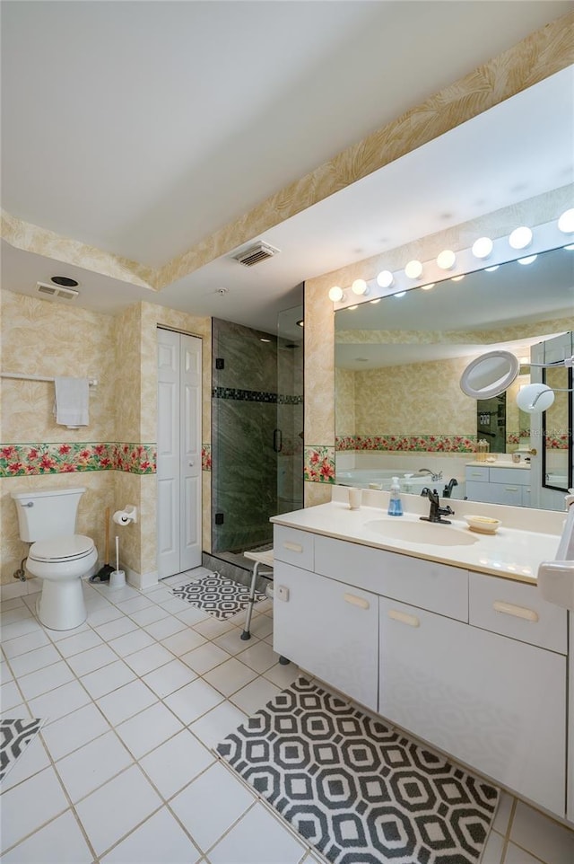 bathroom featuring tile patterned flooring, vanity, an enclosed shower, and toilet