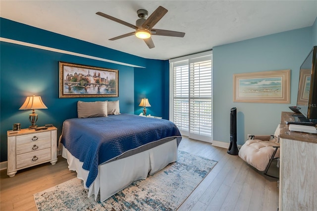 bedroom with ceiling fan and light wood-type flooring