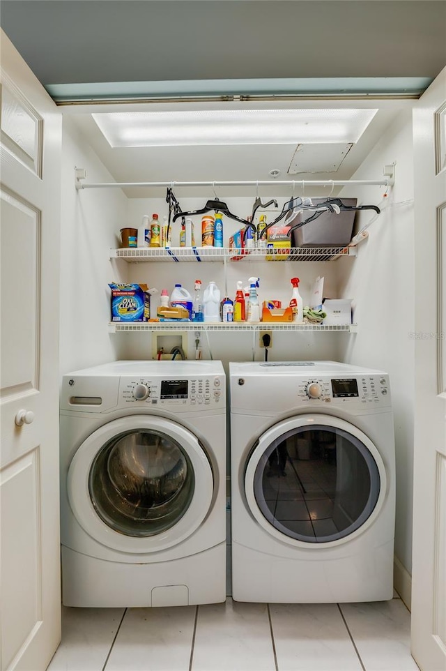 washroom with light tile patterned flooring and washer and dryer