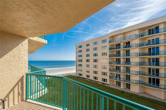 balcony featuring a beach view and a water view