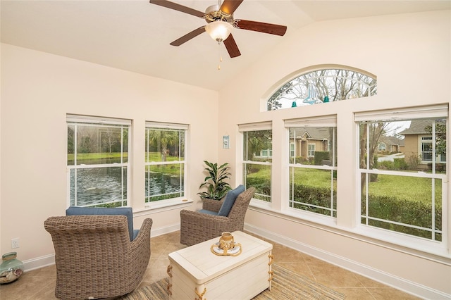 sunroom with a water view, lofted ceiling, and ceiling fan