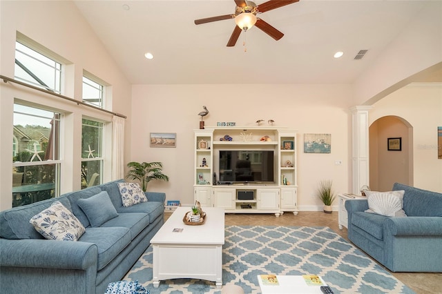 living room featuring ceiling fan, vaulted ceiling, and ornate columns