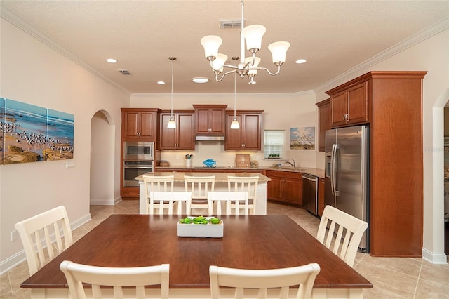 tiled dining room with sink, crown molding, a textured ceiling, and a chandelier