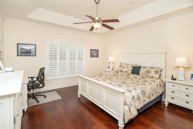 bedroom featuring ceiling fan, ornamental molding, a tray ceiling, and dark hardwood / wood-style floors