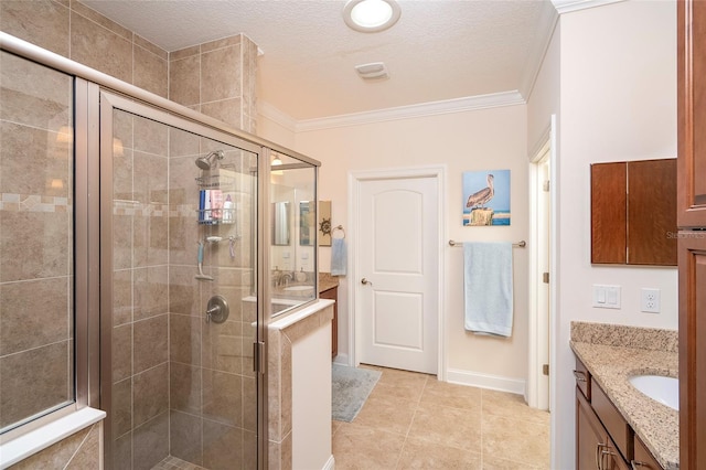 bathroom with an enclosed shower, a textured ceiling, ornamental molding, vanity, and tile patterned flooring