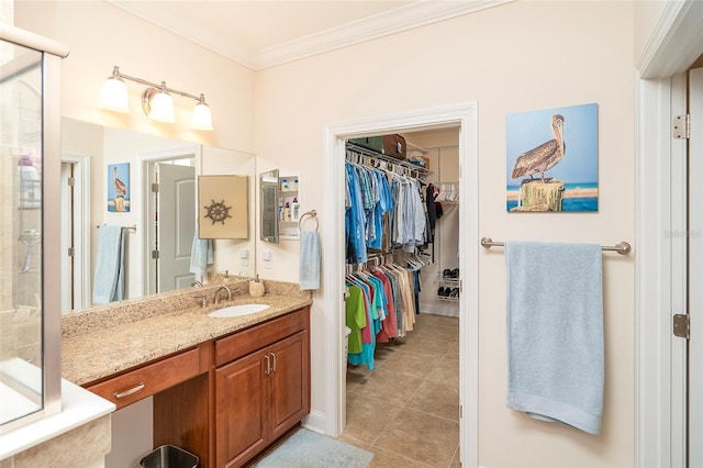 bathroom featuring tile patterned flooring, ornamental molding, and vanity