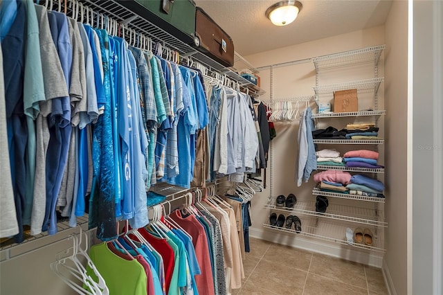 spacious closet featuring light tile patterned floors