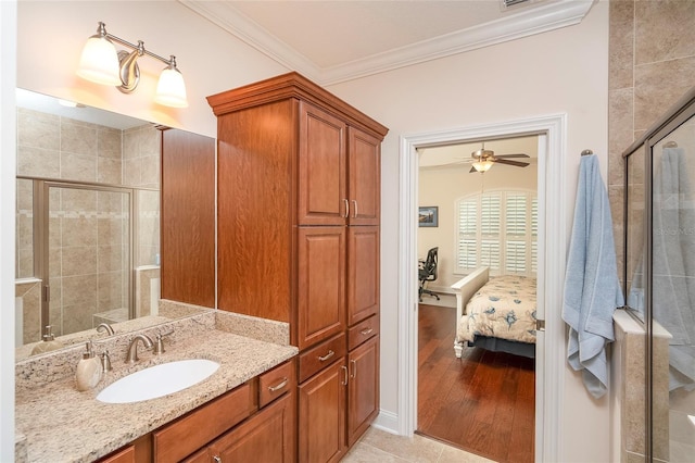 bathroom featuring crown molding, vanity, walk in shower, and hardwood / wood-style floors