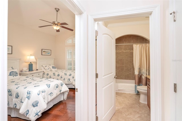 bedroom with crown molding, ensuite bathroom, and ceiling fan