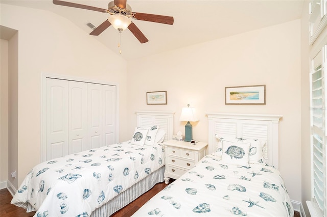 bedroom with dark hardwood / wood-style flooring, vaulted ceiling, a closet, and ceiling fan