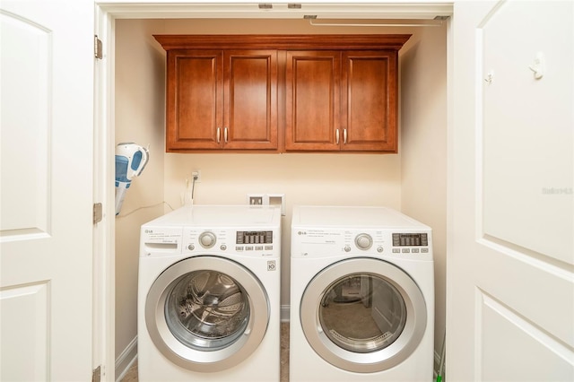 laundry room with cabinets and washer and dryer