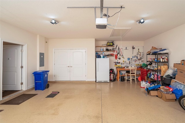 garage featuring a garage door opener, electric panel, and white refrigerator