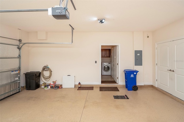 garage with a garage door opener, washer / dryer, and electric panel