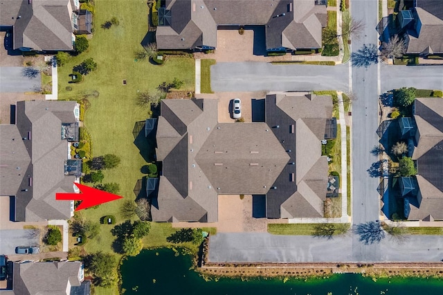 birds eye view of property with a water view