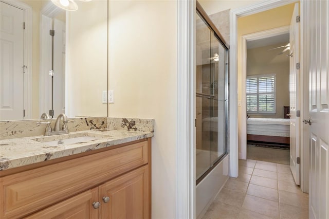 ensuite bathroom with enclosed tub / shower combo, connected bathroom, vanity, and tile patterned floors