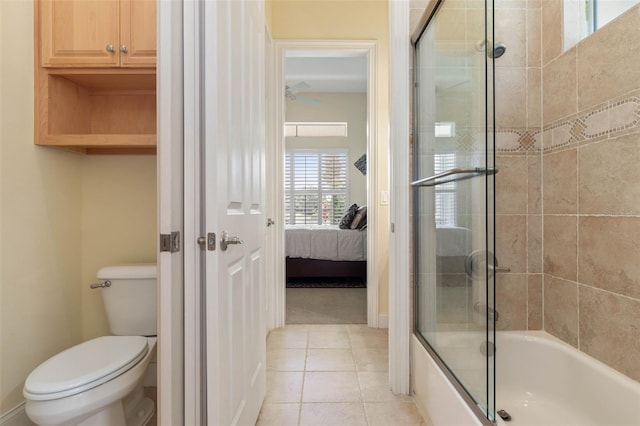 ensuite bathroom featuring bath / shower combo with glass door, baseboards, toilet, ensuite bathroom, and tile patterned flooring