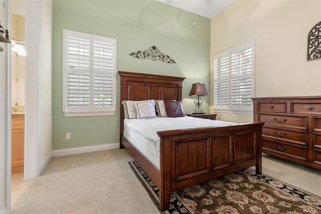 bedroom featuring carpet, multiple windows, and baseboards