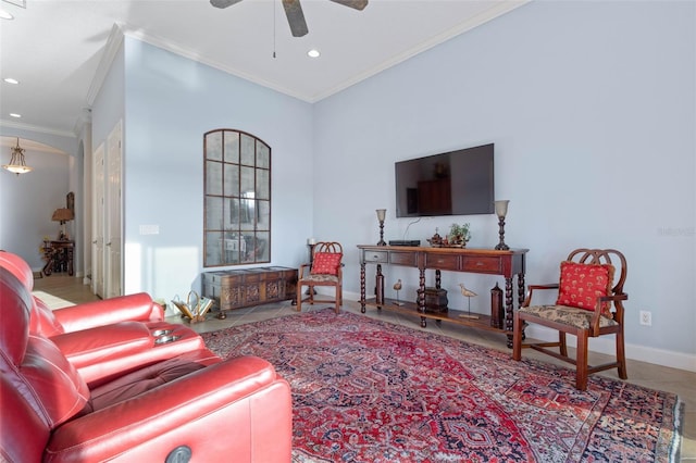 tiled living room featuring ceiling fan, baseboards, crown molding, and recessed lighting