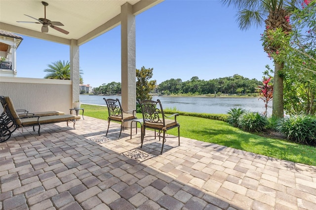 view of patio featuring ceiling fan and a water view