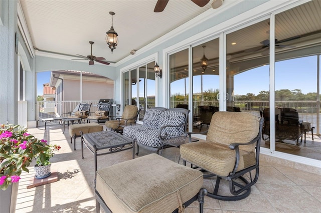 sunroom featuring a wealth of natural light and a ceiling fan