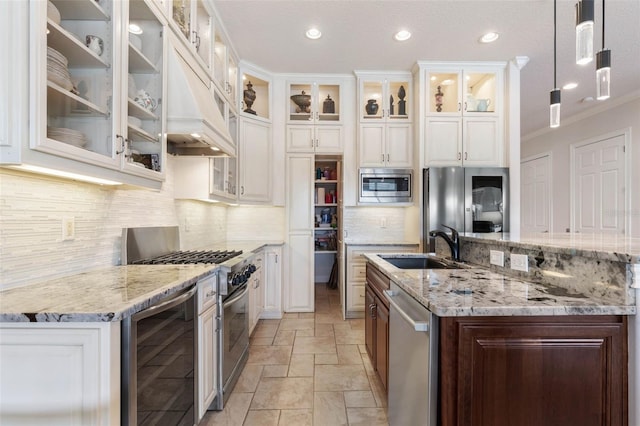 kitchen featuring appliances with stainless steel finishes, beverage cooler, a sink, and light stone counters