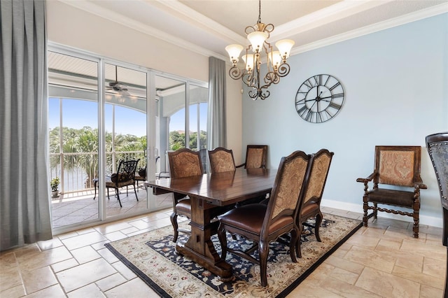 dining space featuring baseboards, a raised ceiling, stone tile flooring, and ornamental molding