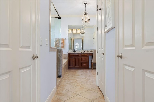 full bath featuring tile patterned floors, crown molding, vanity, a chandelier, and a walk in shower