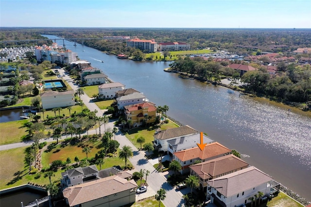 drone / aerial view featuring a water view and a residential view