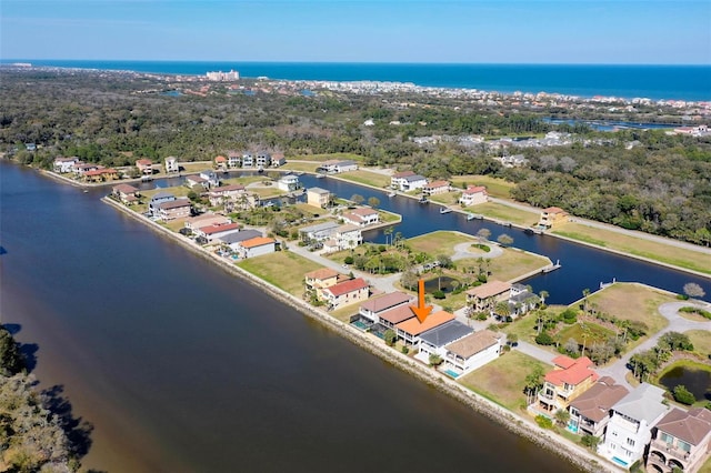 drone / aerial view featuring a water view and a residential view