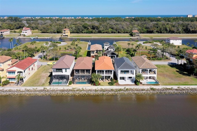 drone / aerial view with a water view and a residential view