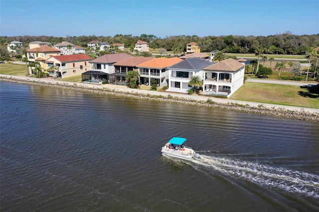 drone / aerial view with a water view and a residential view