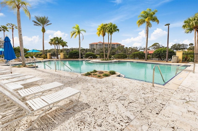 pool featuring a patio and fence