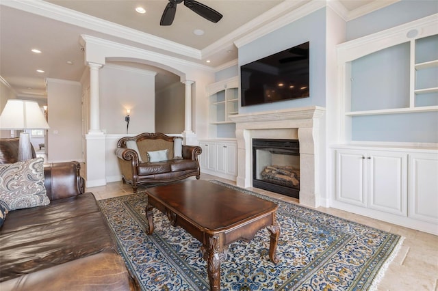 tiled living area featuring ceiling fan, recessed lighting, a fireplace, ornate columns, and crown molding