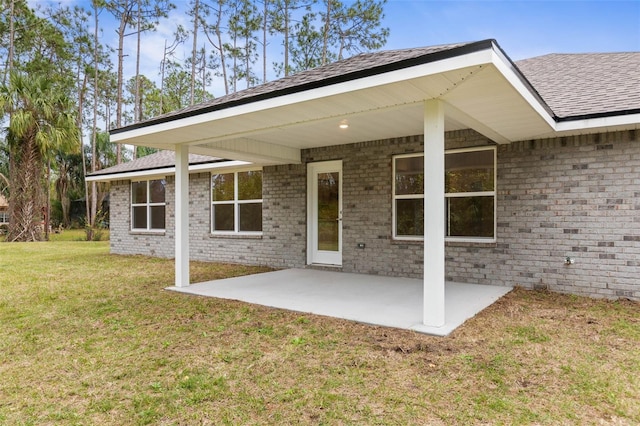 back of property featuring a patio area and a lawn