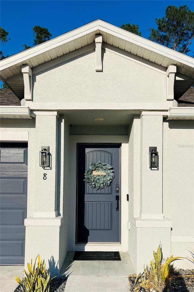 doorway to property with a garage