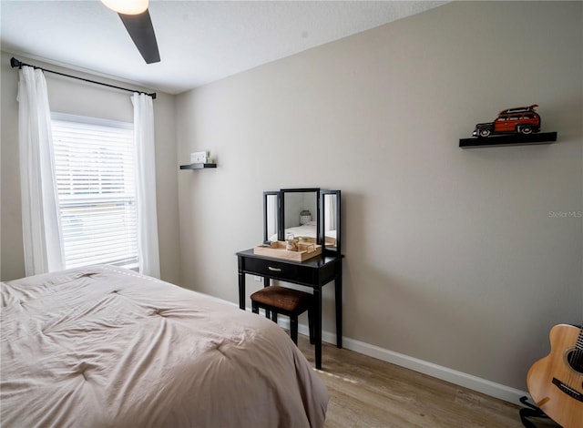 bedroom with ceiling fan and light hardwood / wood-style floors